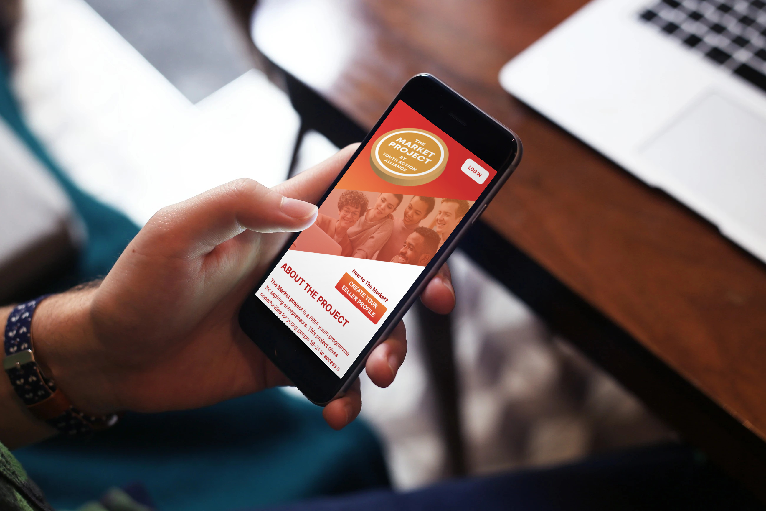 The Market Project app on an iphone held by a user.
